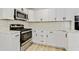 Beautiful kitchen with stainless steel appliances, white cabinets, and light wood floors at 120 Ingleside Dr, Jonesboro, GA 30236