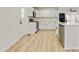 Stylish kitchen with white cabinets, black hardware, stainless steel appliances, and light wood floors at 120 Ingleside Dr, Jonesboro, GA 30236