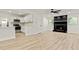 Inviting living space showcases a modern kitchen with white cabinets and a cozy fireplace at 120 Ingleside Dr, Jonesboro, GA 30236
