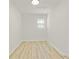 Small room with light wood floors and a window provides natural light at 120 Ingleside Dr, Jonesboro, GA 30236
