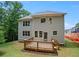 Two-story house exterior featuring a wood deck and lush green lawn in the backyard at 2463 Whites Rdg, Decatur, GA 30034