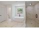 Luxurious bathroom with freestanding tub, glass-enclosed shower, and stylish tile flooring at 2463 Whites Rdg, Decatur, GA 30034