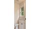 A bathroom with white cabinets, a toilet, and a window providing natural light and ventilation at 2463 Whites Rdg, Decatur, GA 30034