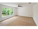 Neutral bedroom with carpet, ceiling fan, and big windows letting in natural light overlooking the backyard at 2463 Whites Rdg, Decatur, GA 30034