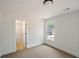Minimalist bedroom with neutral walls, large window, carpeted floor and doorway at 2463 Whites Rdg, Decatur, GA 30034