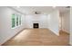 Spacious living room with hardwood floors, large windows, recessed lighting, and a cozy fireplace at 2463 Whites Rdg, Decatur, GA 30034