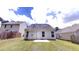 Wide shot of home's backyard with green grass, privacy fence, and access to home via rear entrance at 3827 Shenfield Dr, Union City, GA 30291