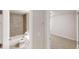 Bathroom featuring tiled shower and tub and toilet with door leading to carpeted bedroom at 3827 Shenfield Dr, Union City, GA 30291