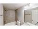 Bathroom featuring tiled shower and tub and toilet with updated mirror and lighting at 3827 Shenfield Dr, Union City, GA 30291