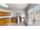 Bright kitchen with wood cabinetry, stainless appliances, and an open view to the living room at 3827 Shenfield Dr, Union City, GA 30291