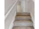 Carpeted staircase leading to the upper level of the home featuring neutral walls and white trim at 3827 Shenfield Dr, Union City, GA 30291
