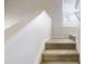 A carpeted stairway leading to an upper floor, illuminated by a window at 3827 Shenfield Dr, Union City, GA 30291