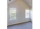 Bedroom with neutral paint, carpet, and two windows at 4162 Ward Lake Trl, Ellenwood, GA 30294