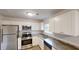 Stylish kitchen with stainless appliances, granite countertops, tile flooring, and white cabinetry at 4162 Ward Lake Trl, Ellenwood, GA 30294