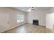 Spacious living room boasts wood-look floors, white trim, a fireplace, and plenty of natural light at 4162 Ward Lake Trl, Ellenwood, GA 30294