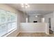Bright living room featuring tile flooring, fireplace, and access to the upper-level living spaces at 4162 Ward Lake Trl, Ellenwood, GA 30294