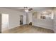 Open concept living space featuring a staircase, wood-look floors, fireplace, and an adjacent kitchen at 4162 Ward Lake Trl, Ellenwood, GA 30294