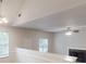 Spacious living area with vaulted ceilings, gas fireplace, and ceiling fan; bright natural light fills the room at 4162 Ward Lake Trl, Ellenwood, GA 30294