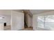 Open-concept living room boasts abundant light from a large window, and direct access to the staircase at 4162 Ward Lake Trl, Ellenwood, GA 30294