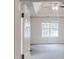 View through the doorway into the main bedroom, featuring a tray ceiling and large window at 4162 Ward Lake Trl, Ellenwood, GA 30294