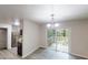 Eat-in kitchen dining area that features a sliding door to the deck and modern lighting at 5574 Oak Grove Dr, Acworth, GA 30102
