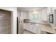 Updated kitchen with stainless steel refrigerator and ample white cabinetry at 5574 Oak Grove Dr, Acworth, GA 30102