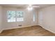 Open living room with a ceiling fan, a large window, and vinyl plank flooring at 5574 Oak Grove Dr, Acworth, GA 30102