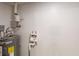 Utility area featuring a newer water heater with updated plumbing at 5574 Oak Grove Dr, Acworth, GA 30102