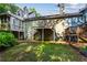 Spacious backyard with mature trees, a wooden deck and stairs, and a fenced perimeter at 812 Manning Sw Way, Marietta, GA 30064