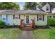 Charming home with a well-maintained lawn, flower beds, and inviting front porch entrance at 812 Manning Sw Way, Marietta, GA 30064