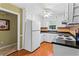 Efficient kitchen with white cabinets, modern appliances, and a ceiling fan at 812 Manning Sw Way, Marietta, GA 30064