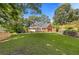 Expansive lawn and brick retaining wall encloses the lushly landscaped backyard with pool at 828 Jami Ct, Lawrenceville, GA 30046