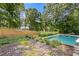 Inviting backyard features a refreshing pool, garden, and privacy fence at 828 Jami Ct, Lawrenceville, GA 30046