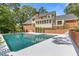 Beautiful backyard and sparkling pool with the home reflected in the water at 828 Jami Ct, Lawrenceville, GA 30046