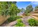 View of the lush backyard, featuring a well-maintained lawn, garden beds, and a wooden fence at 828 Jami Ct, Lawrenceville, GA 30046
