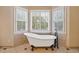 Bright bathroom showcasing a freestanding tub with vintage fixtures and shuttered windows at 828 Jami Ct, Lawrenceville, GA 30046