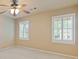 Bedroom with neutral walls, ceiling fan, and large windows at 828 Jami Ct, Lawrenceville, GA 30046