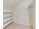 Angled closet with white shelving and neutral carpet at 828 Jami Ct, Lawrenceville, GA 30046
