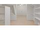 Walk in closet with custom shelving and open space at 828 Jami Ct, Lawrenceville, GA 30046