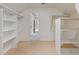 Walk in closet with white shelving and neutral carpet at 828 Jami Ct, Lawrenceville, GA 30046