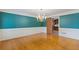 Formal dining room with hardwood floors, wainscoting, elegant chandelier, and access to the kitchen at 828 Jami Ct, Lawrenceville, GA 30046