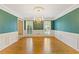 Spacious dining room with hardwood floors, wainscoting, and view of the shuttered windows at 828 Jami Ct, Lawrenceville, GA 30046