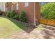 Exterior of a brick home featuring rock wall, greenery and a wooden fence on a sunny day at 828 Jami Ct, Lawrenceville, GA 30046