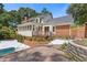 Exterior shot of the home, highlighting the pool, deck, and landscaping at 828 Jami Ct, Lawrenceville, GA 30046