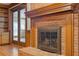 Close up of the brick fireplace with wooden mantel and glass door insert in living room at 828 Jami Ct, Lawrenceville, GA 30046