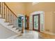 Grand foyer featuring a staircase, elegant tile flooring, and front door with decorative glass at 828 Jami Ct, Lawrenceville, GA 30046