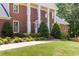 Elegant front entrance with a glass door, brick steps, and well-maintained landscaping at 828 Jami Ct, Lawrenceville, GA 30046