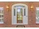Detailed front door of a brick home with a glass window and decorative transom and a Welcome Mat at 828 Jami Ct, Lawrenceville, GA 30046