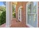 Beautiful red brick front porch with white columns, decorative lighting, and a 'Welcome' mat at 828 Jami Ct, Lawrenceville, GA 30046