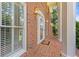 Inviting red brick front porch with stately columns and classic architectural details at 828 Jami Ct, Lawrenceville, GA 30046